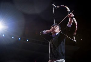 Image of man with bow and arrow at Ted talk
