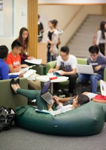 Students relax in chairs in Chifley Library