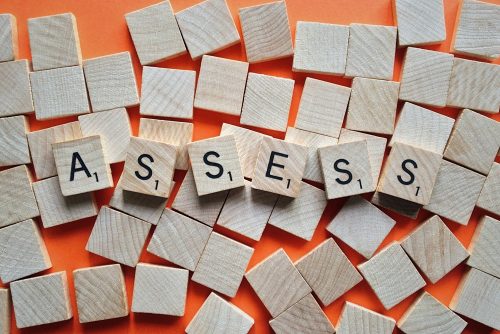 Image of tiles with letters for the word "assess"